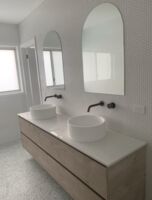 Arched top polished edge mirror in bathroom